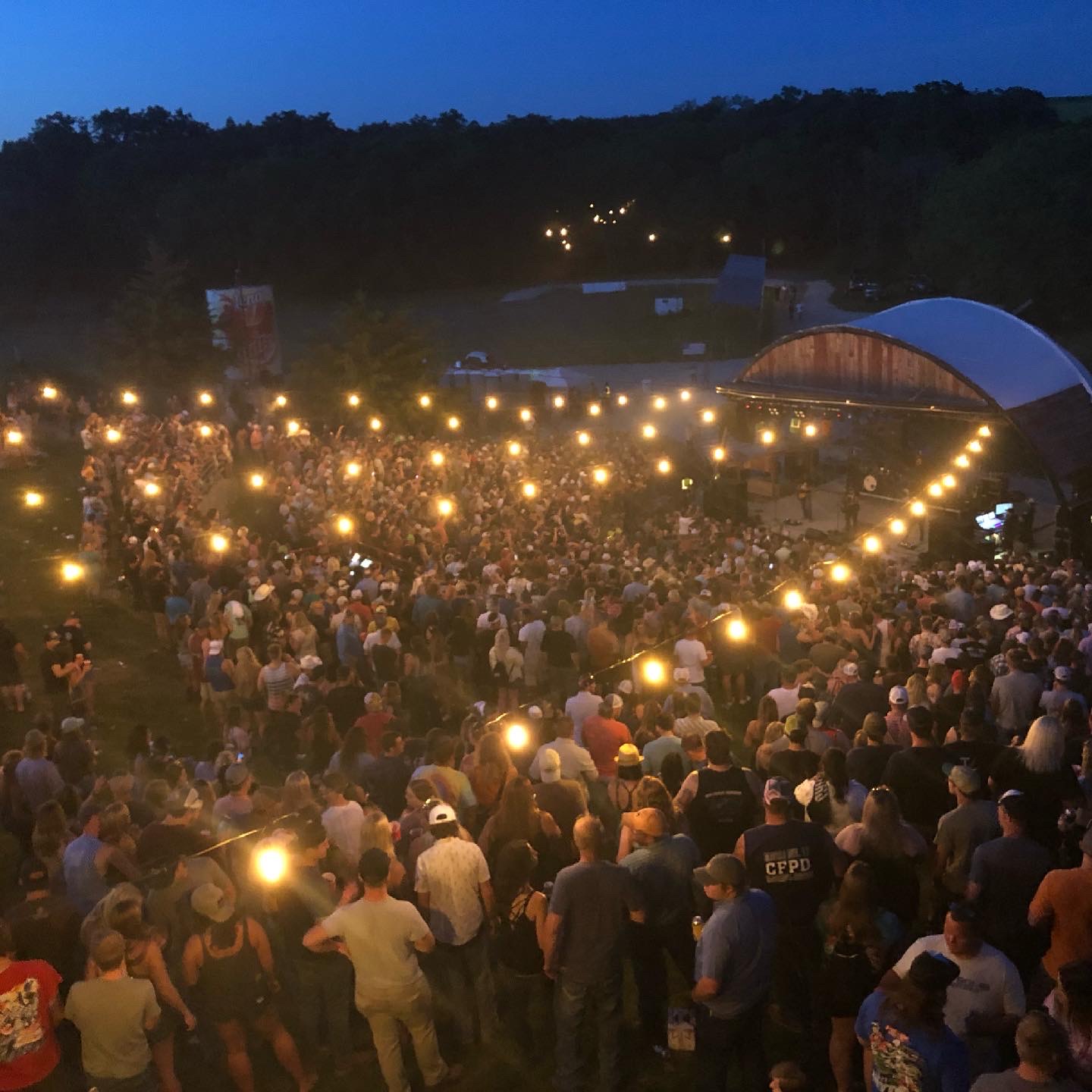 Outdoor festival crowd at dusk